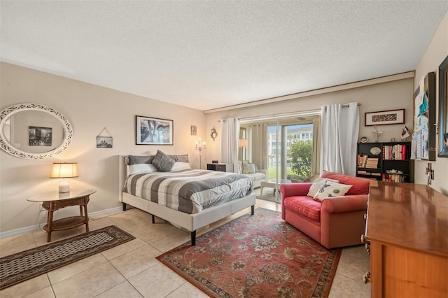 bedroom featuring light tile patterned floors and a textured ceiling