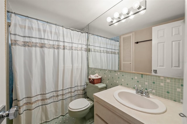 bathroom with tile patterned floors, vanity, toilet, and backsplash