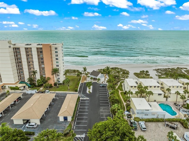 drone / aerial view with a water view and a view of the beach