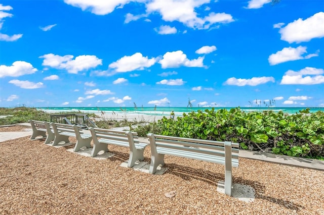 surrounding community featuring a water view and a view of the beach