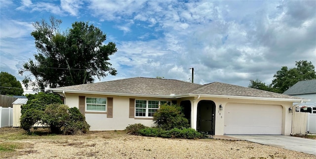 single story home with concrete driveway, an attached garage, fence, and stucco siding