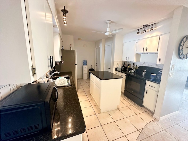 kitchen featuring electric range, decorative backsplash, a center island, and white cabinets