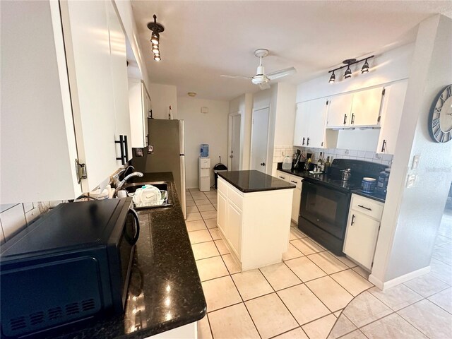 108 Shell Rd, Venice, FL 34293 - kitchen featuring black appliances, decorative backsplash, light tile patterned floors, a sink, and a ceiling fan