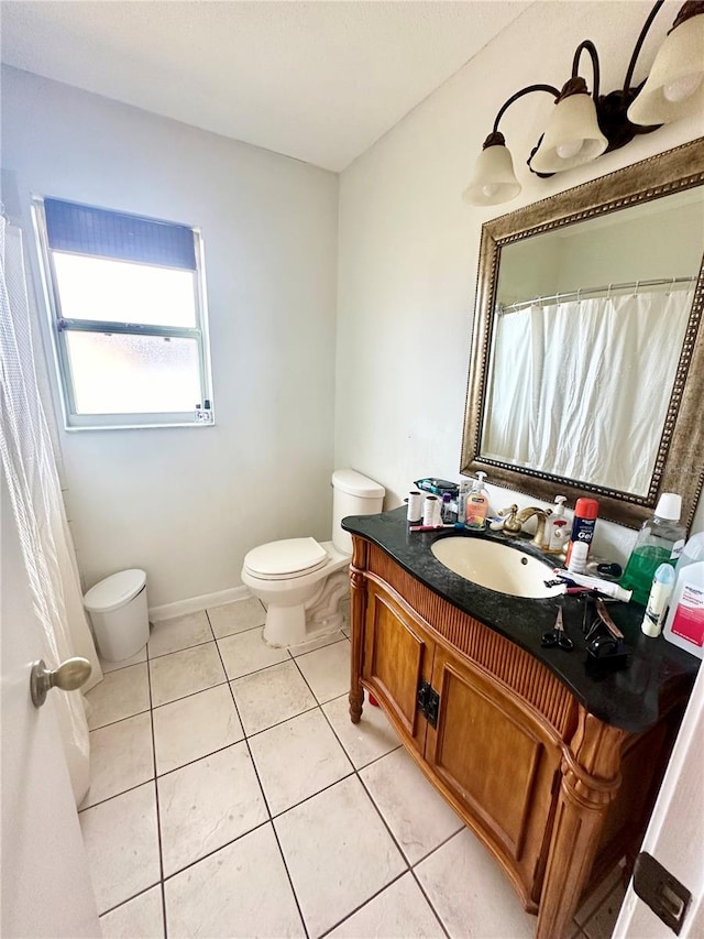 bathroom with tile patterned floors, vanity, and toilet