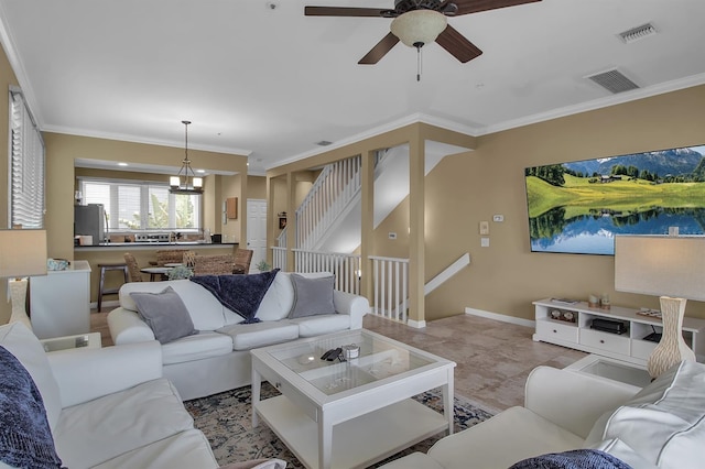 living room with ceiling fan with notable chandelier and ornamental molding