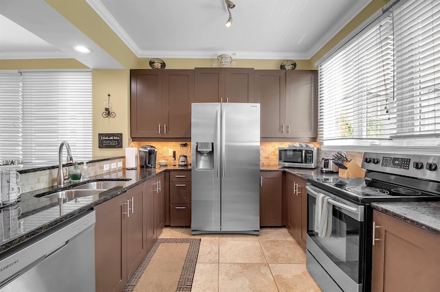 kitchen with sink, stainless steel appliances, tasteful backsplash, light tile patterned flooring, and ornamental molding