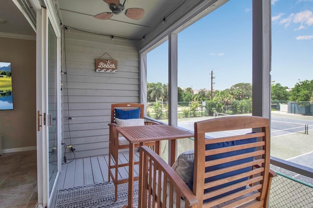 sunroom / solarium featuring ceiling fan