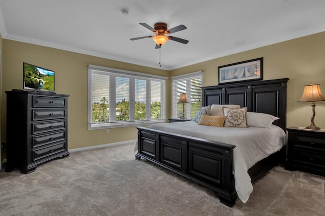 carpeted bedroom with ceiling fan and crown molding