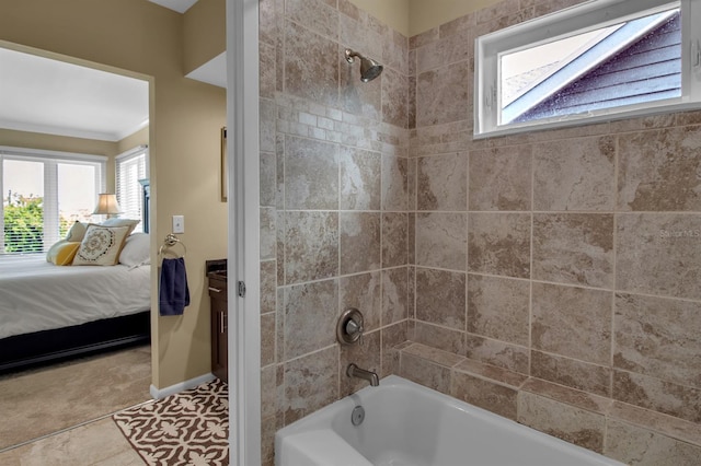 bathroom with tile patterned flooring, tiled shower / bath, and a healthy amount of sunlight