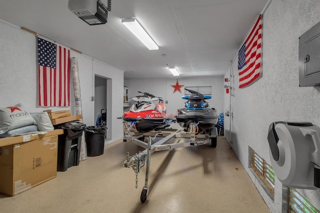 garage with electric panel and a garage door opener