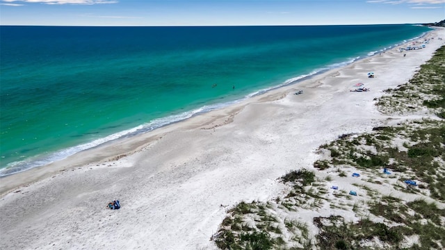 drone / aerial view with a view of the beach and a water view