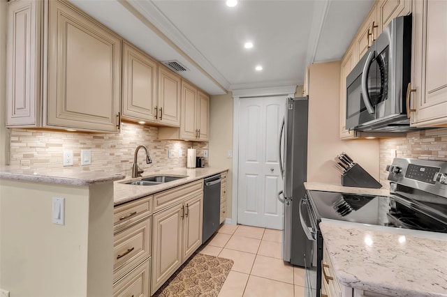 4119 61st Avenue Terrace W Unit 105, Bradenton, FL 34210 - kitchen with stainless steel appliances, a sink, cream cabinets, light tile patterned floors, and recessed lighting