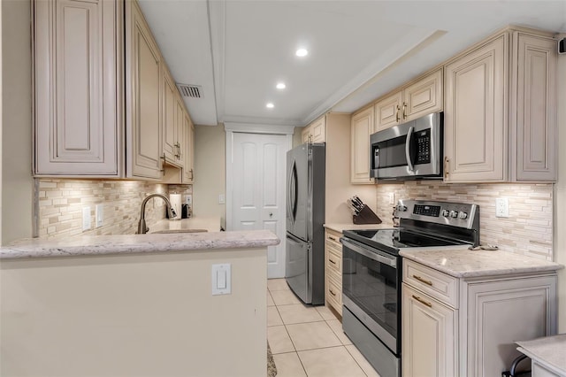4119 61st Avenue Terrace W Unit 105, Bradenton, FL 34210 - kitchen featuring appliances with stainless steel finishes, cream cabinets, a sink, light tile patterned floors, and recessed lighting