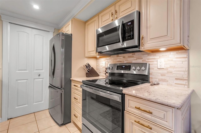 4119 61st Avenue Terrace W Unit 105, Bradenton, FL 34210 - kitchen with stainless steel appliances, cream cabinets, backsplash, and light tile patterned floors