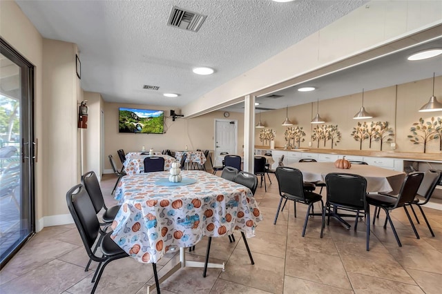 4119 61st Avenue Terrace W Unit 105, Bradenton, FL 34210 - dining area featuring a textured ceiling, plenty of natural light, and baseboards