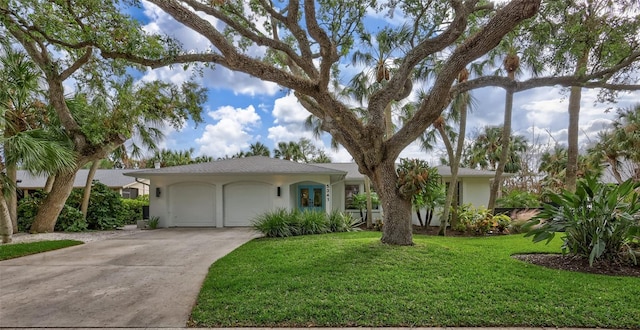 ranch-style home with a front yard and a garage