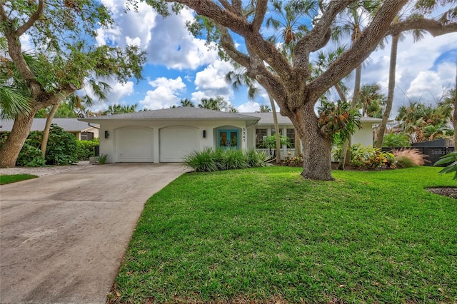 ranch-style home featuring a front yard and a garage