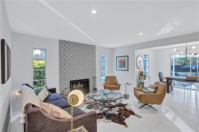 living room with a fireplace and an inviting chandelier