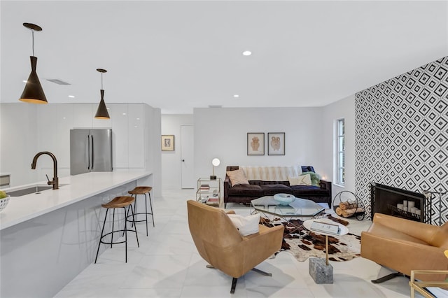 living room with a fireplace and sink