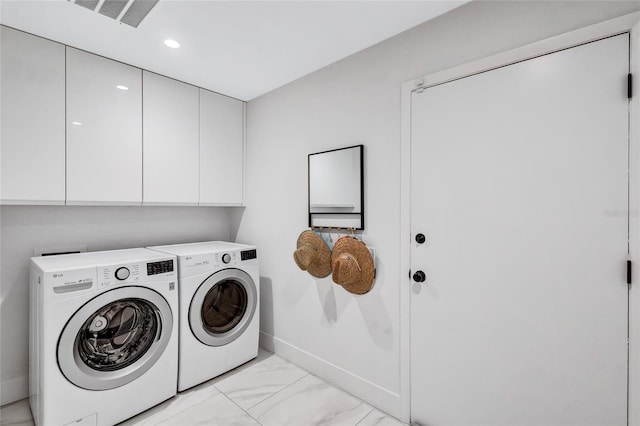 laundry area with cabinets and separate washer and dryer