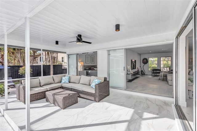 sunroom featuring ceiling fan and wood ceiling