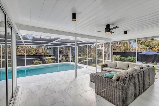 view of pool featuring outdoor lounge area, a patio, and glass enclosure