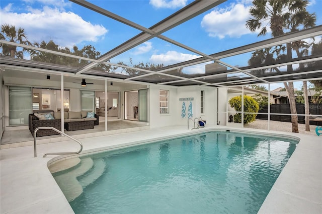 view of pool with a lanai, an outdoor living space, ceiling fan, and a patio