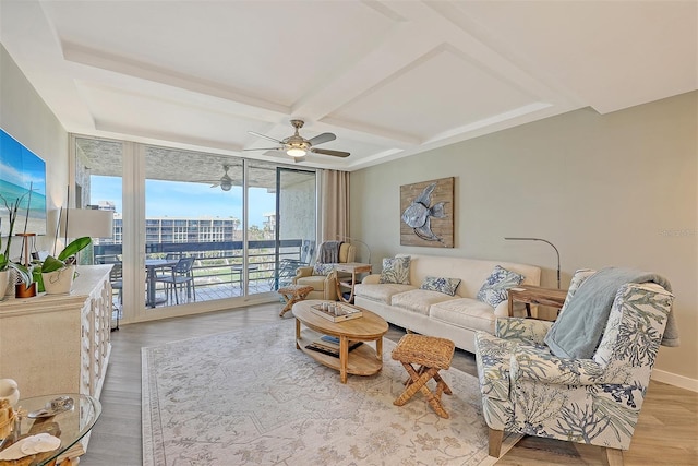 living room featuring floor to ceiling windows, ceiling fan, light hardwood / wood-style floors, and coffered ceiling