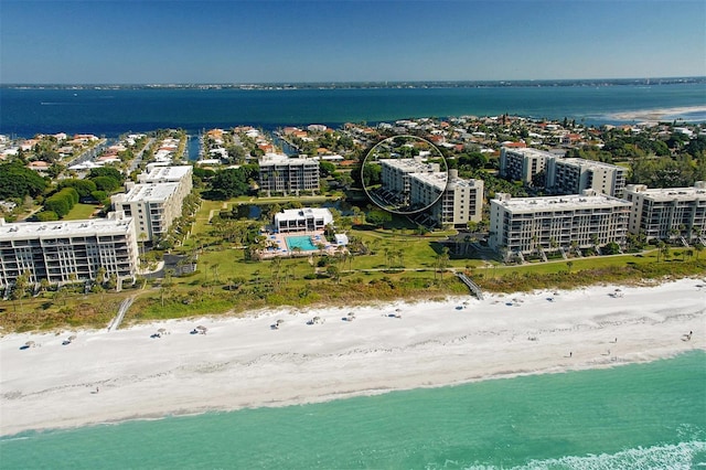 birds eye view of property featuring a beach view and a water view