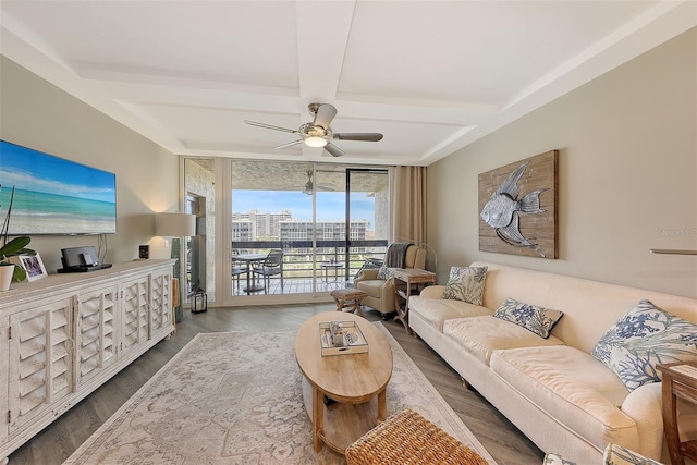 living room featuring coffered ceiling, ceiling fan, dark wood-type flooring, beam ceiling, and floor to ceiling windows