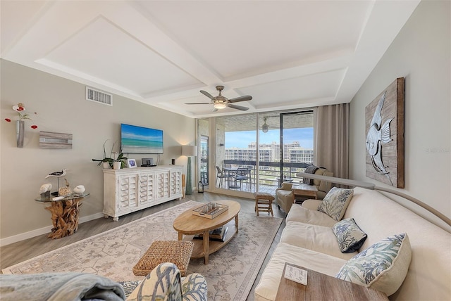 living room with wood-type flooring, ceiling fan, floor to ceiling windows, and beamed ceiling