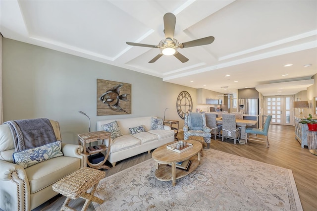 living room featuring ceiling fan and light hardwood / wood-style flooring