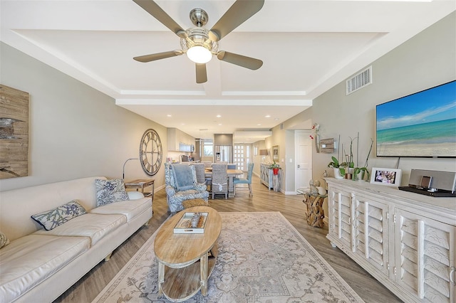 living room with ceiling fan and hardwood / wood-style floors