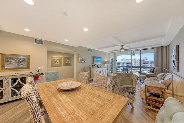 dining area with ceiling fan, light hardwood / wood-style floors, coffered ceiling, floor to ceiling windows, and beam ceiling