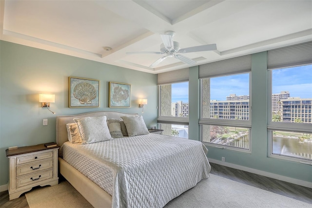 bedroom with ceiling fan, coffered ceiling, and beam ceiling