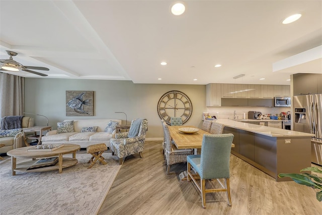 interior space with sink, light wood-type flooring, and ceiling fan