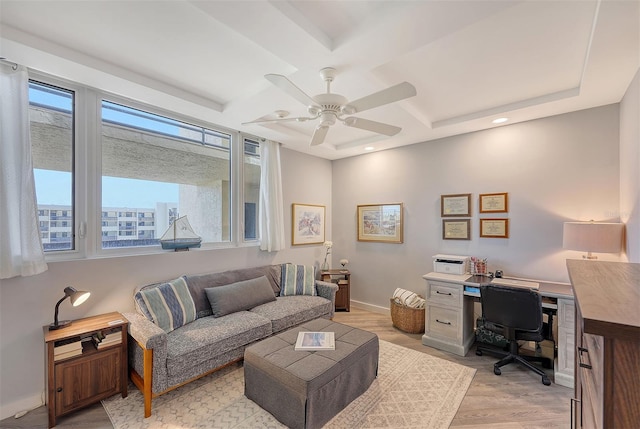 office area with coffered ceiling, ceiling fan, light hardwood / wood-style floors, and plenty of natural light