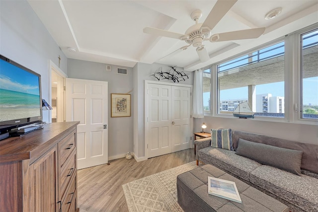 living room featuring ceiling fan and light hardwood / wood-style flooring