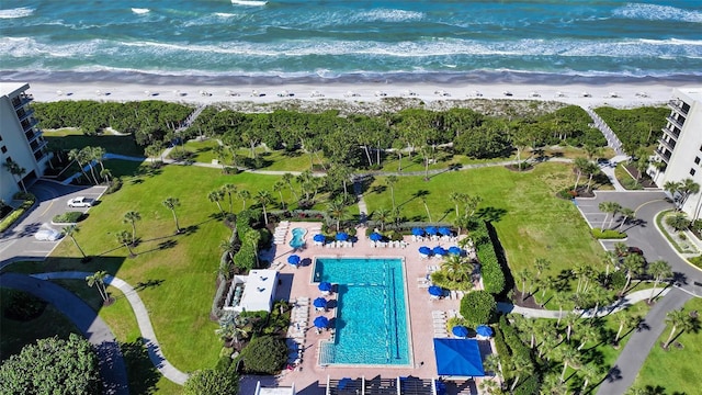 birds eye view of property with a view of the beach and a water view