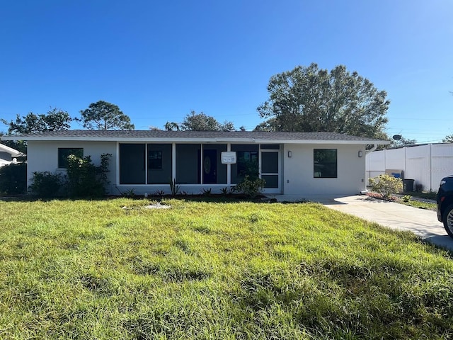 ranch-style home with a front lawn