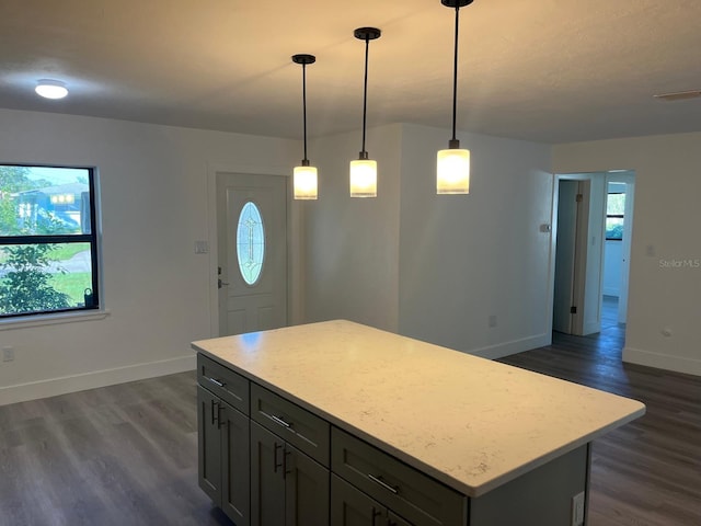 kitchen featuring gray cabinets, decorative light fixtures, dark hardwood / wood-style floors, and a kitchen island