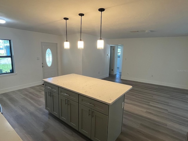 kitchen featuring pendant lighting, dark hardwood / wood-style flooring, gray cabinets, and plenty of natural light