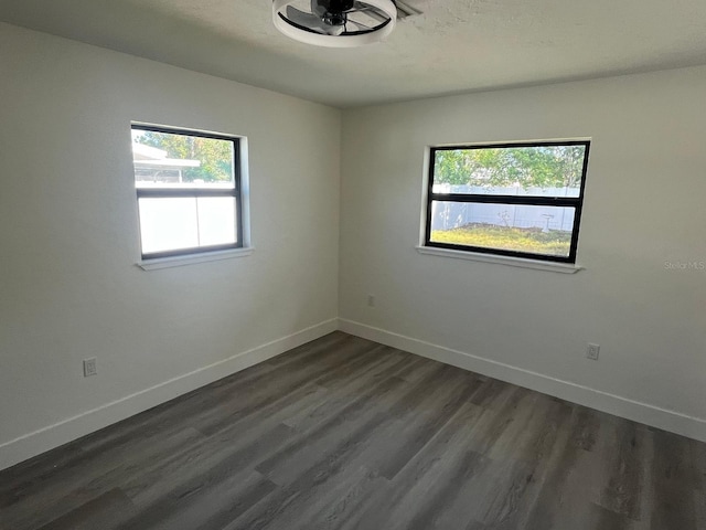 empty room with dark wood-type flooring