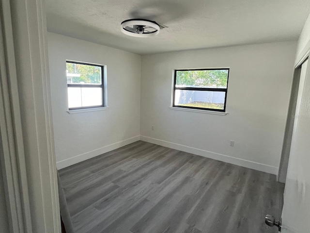 unfurnished room with hardwood / wood-style flooring