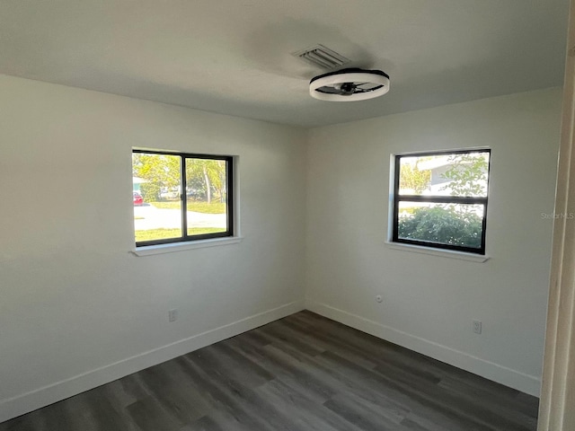 unfurnished room with dark hardwood / wood-style flooring