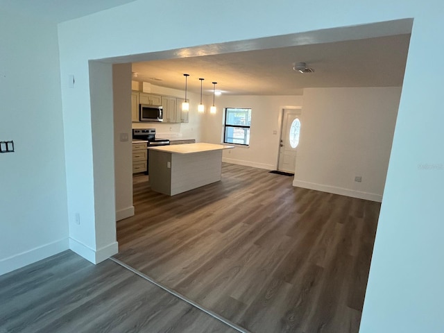 kitchen featuring white cabinetry, a center island, dark wood-type flooring, and appliances with stainless steel finishes