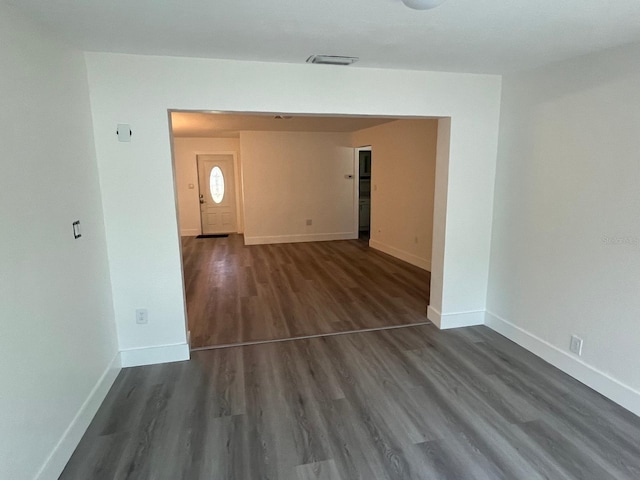 spare room with dark hardwood / wood-style floors