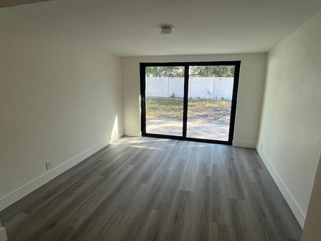 empty room with dark wood-type flooring