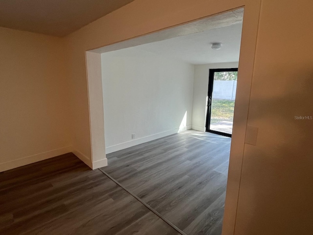 empty room with dark hardwood / wood-style floors