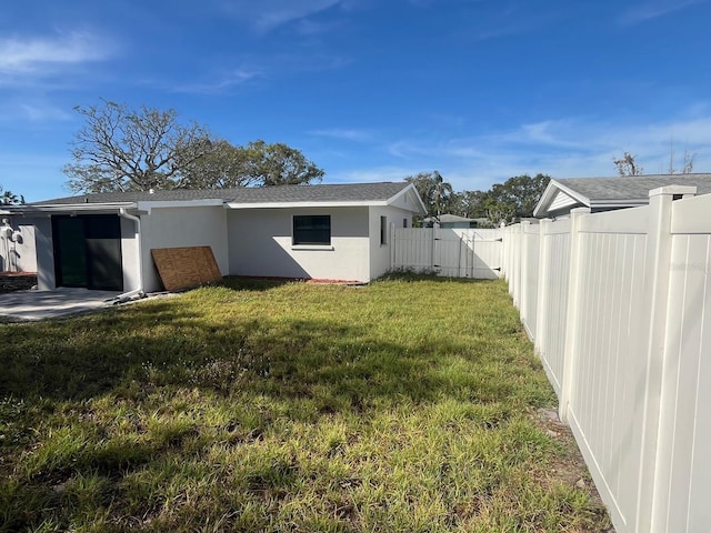 rear view of house featuring a yard